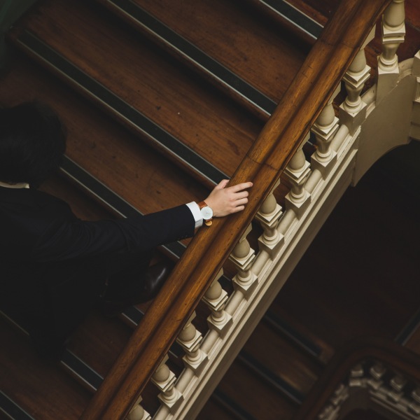 McKenzie Friend walking up courthouse stairs in formal attire – legal support in UK family courts